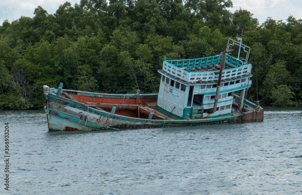 Old boat with severe impact, outside Krabi in southern Thailand.