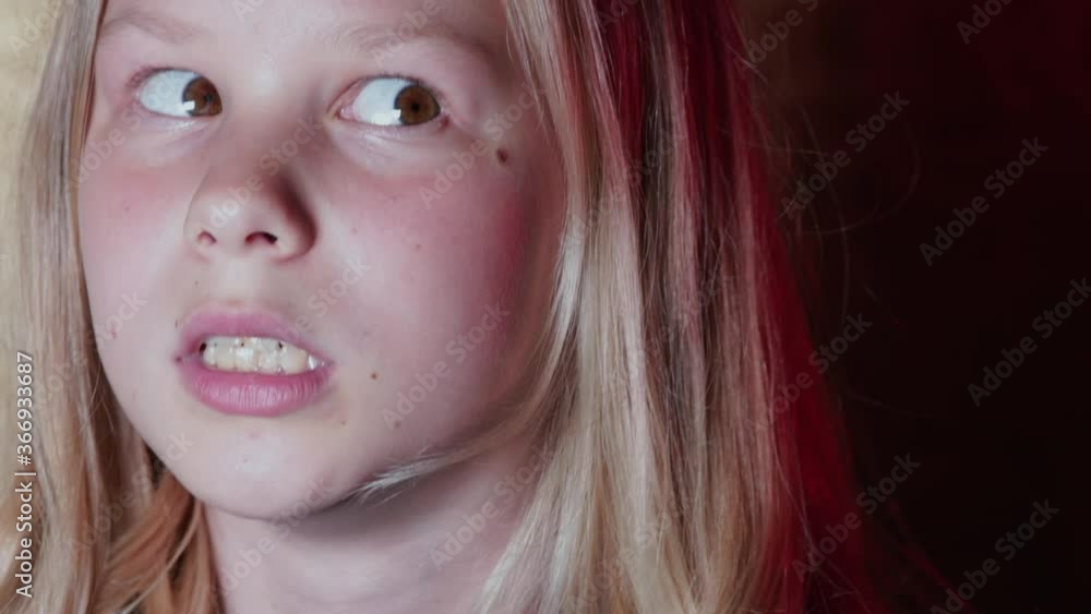 Teenage girl shows movement of her eyes to the side. Fun moments of joy while interacting with peers. Ridiculous behavior reduces social distortion. Teenage girl shows movement of her eyes to the side. Fun moments of joy while interacting with peers. Ridiculous behavior reduces social distortion.