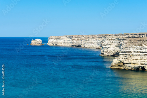 Beautiful view of blue sea and mountain. Calm water in bay with rock, sunny day