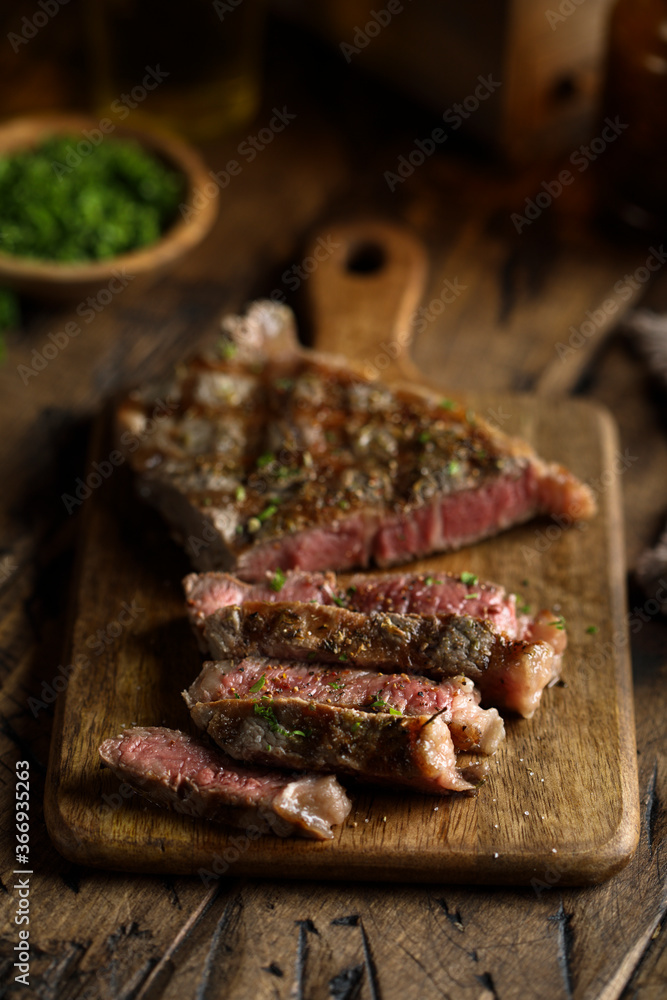 Roasted beef steak on a wooden desk Roasted beef steak on a wooden desk