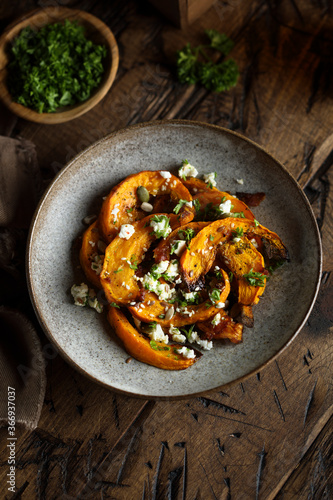 Healthy roasted pumpkin with cheese and herbs
