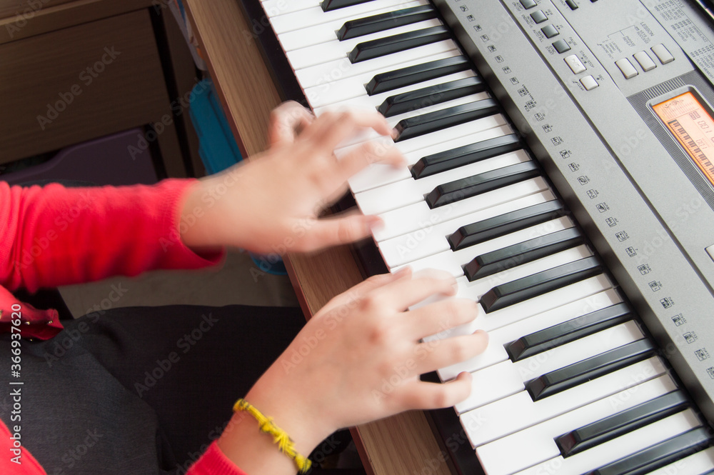 Fototapeta premium background with hands playing an electronic musical keyboard