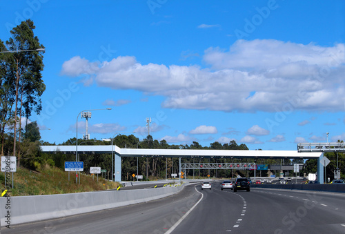 Overhead road toll scanners. Sydney city road / freeway. The M4 Motorway is a 50.2-kilometre-long dual carriageway partially tolled motorway in Sydney © Rose Makin