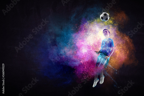 Fototapeta Naklejka Na Ścianę i Meble -  Boy playing soccer hitting the ball