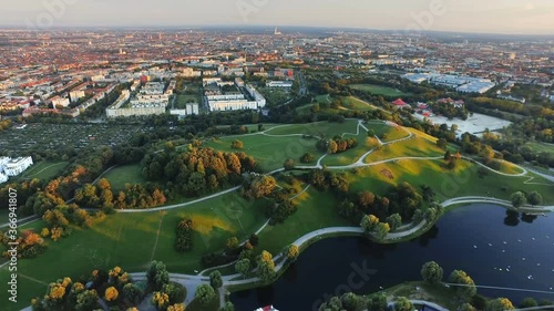 Aerial view of Munich City, Olympia Park with green grass field in summer from Olympiaturm (Olympic Tower) in Munich, Germany before sunset