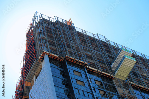 Top of a high rise construction site showing scaffolding, loading platforms and sky. North Sydney Australia photo