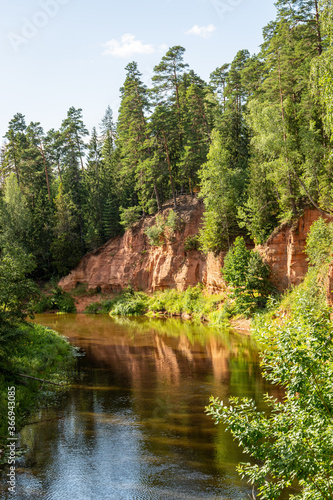 View to the Ne    u  Nelku   red sanstone cliffs at the river Salaca in Ska  aiskalns  Skanaiskalns  Nature Park in Mazsalaca in July in Latvia