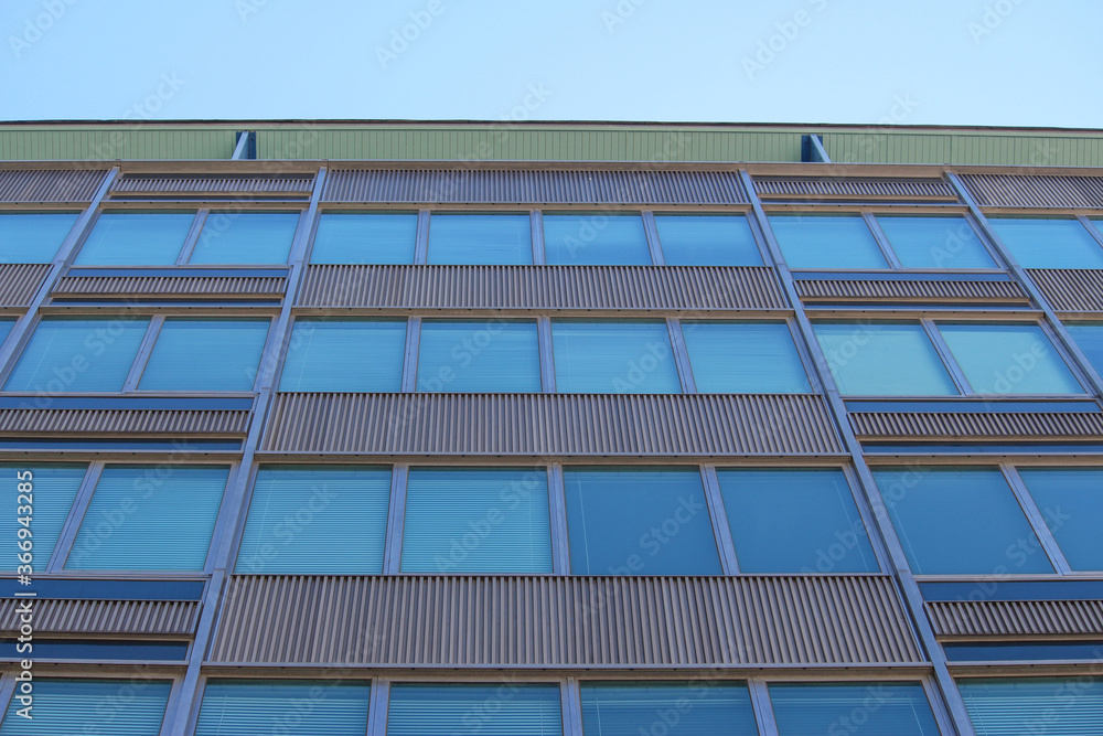 Fototapeta premium Abstract close up of a Mid-century vintage office building with a blue sky