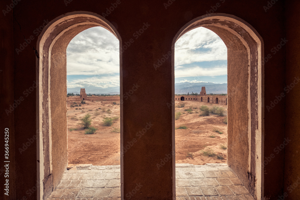 Ruins of Shafiabad caravanserai viewed through a window, Kerman Province, Iran