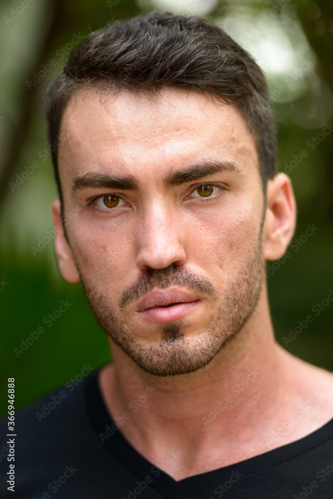 Face of handsome bearded man in the park outdoors Face of handsome bearded man in the park outdoors