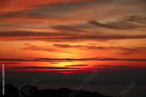 The red sky sunrise in the morning time with cloudy background