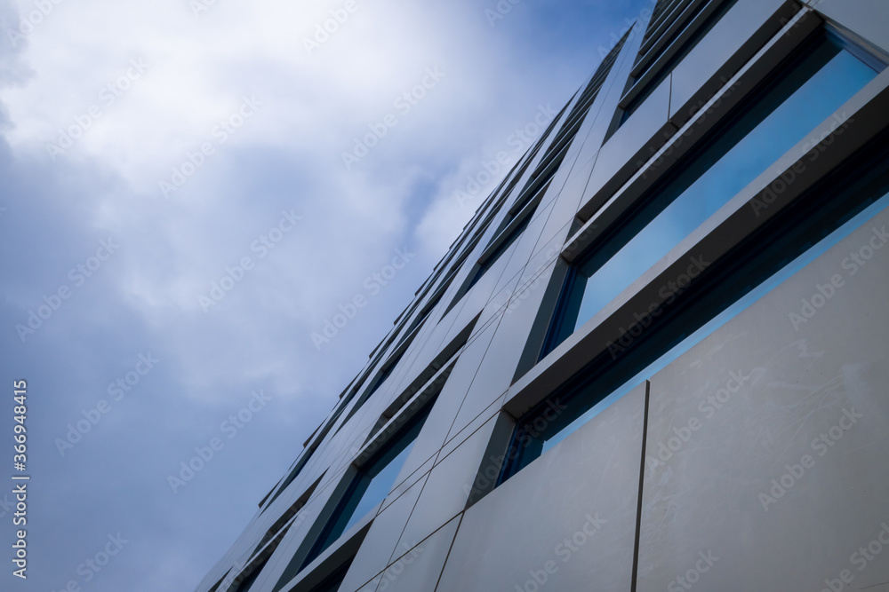 Upward view of the exterior wall of metal composite panels and closed ...