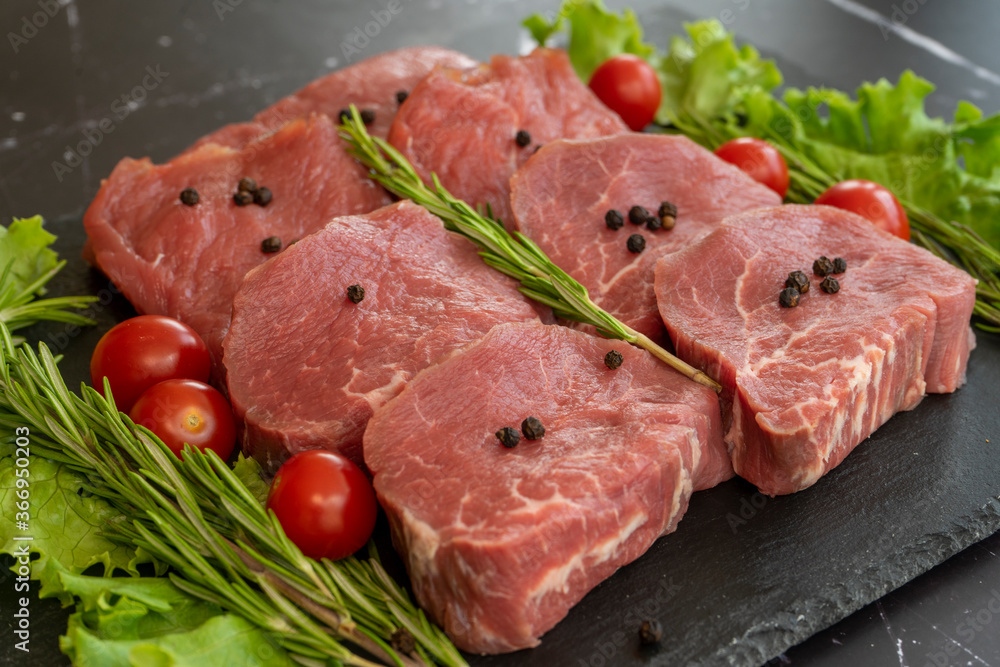 raw meat on a black background