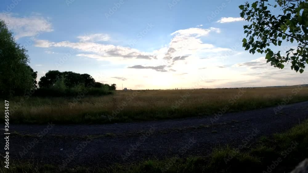 Sunset time lapse in an English meadow with lovely cloud movement Sunset time lapse in an English meadow with lovely cloud movement