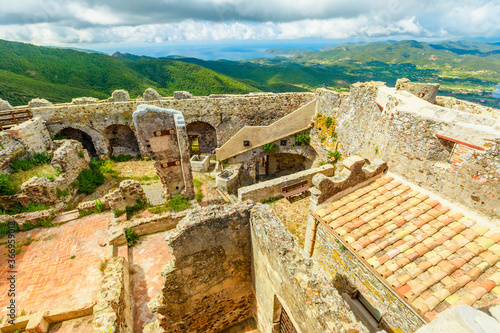 Aerial panorama of ruins of Volterraio Castle, the ancient fortification on Elba Island, Tuscany, Italy, overlooking the gulf of Portoferraio. Panoramic views of Elba.