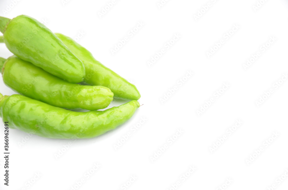 bunch the ripe green chilly isolated on white background. bunch the ripe green chilly isolated on white background.