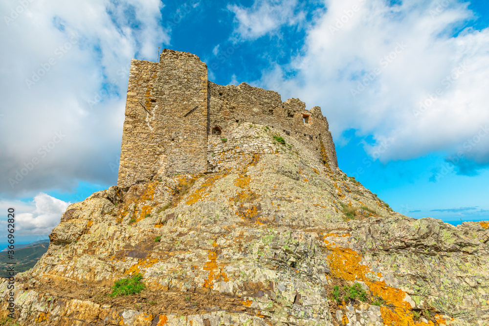 close up view of Volterraio Fortress on rock at 394 m. Volterraio is symbol of Elba Island in Portoferraio Gulf. Panoramic landscape with view from top of Elba mountain. Tuscany, Italy.