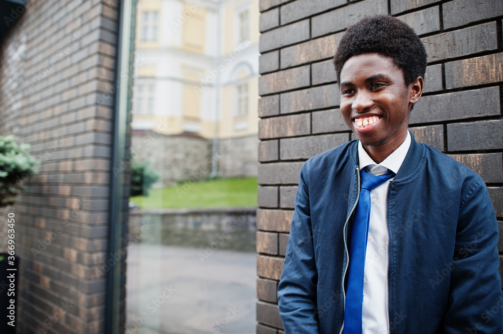 African man wear in tie and casual outfit posing outdoor. African man wear in tie and casual outfit posing outdoor.
