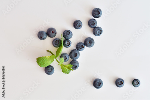 Fresh blueberries with mint leaves isolated on white background. Top vew