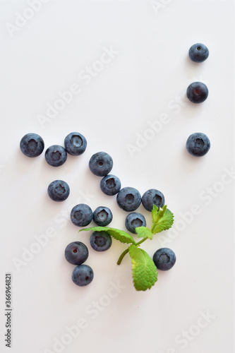 Fresh blueberries with mint leaves isolated on white background. Top vew