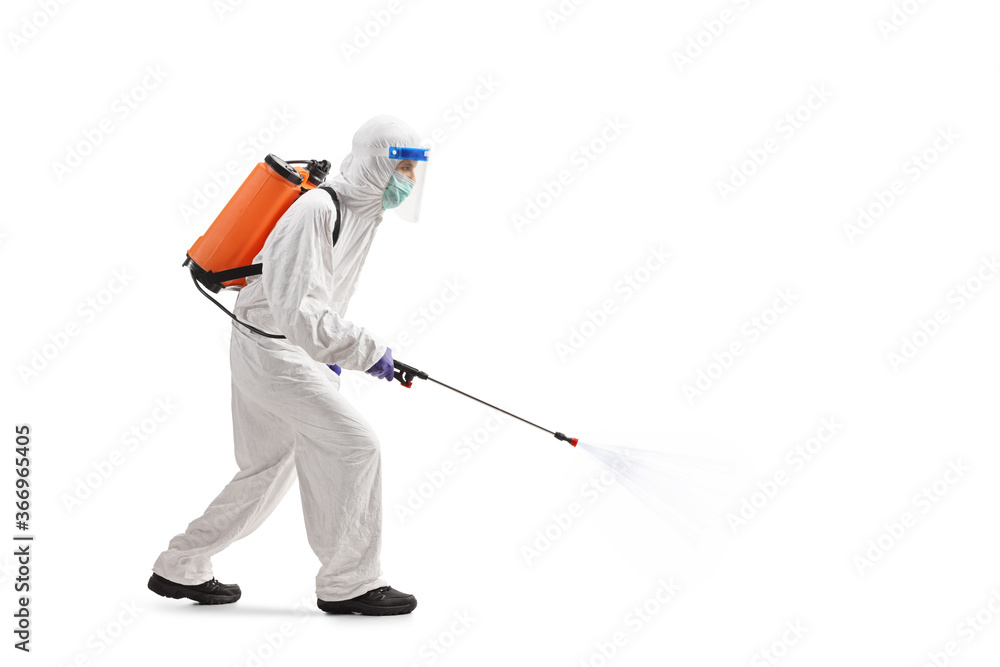 Man in a hazmat suit santizing with a spray Man in a hazmat suit santizing with a spray