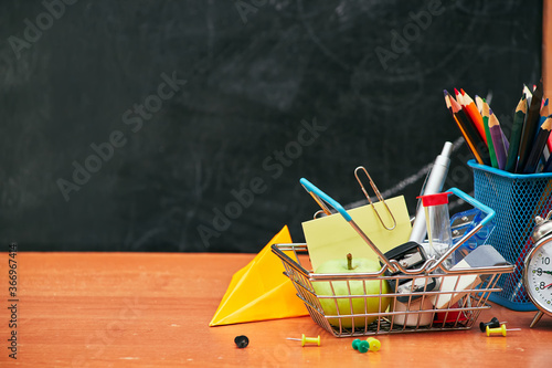 school still life, alarm clock, stand for pencils on the background of a school board, university, college, copy space