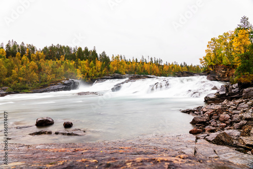 Bardufoss waterfall located in Tamok Valley, Troms og Finnmark region, Norway photo