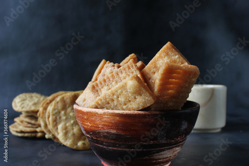 Shakkar pare/shakkarpare/shankar pale is sweet deep fried indian tea time snacks. photo
