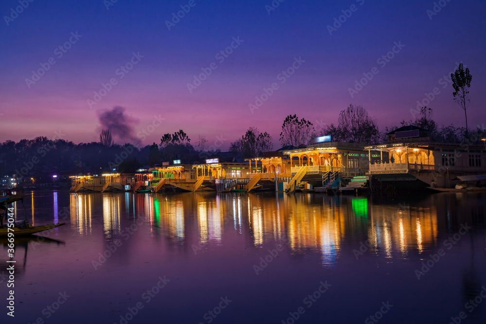 Illuminated Houseboats parked on the bank of Dal Lake in Srinaga Illuminated Houseboats parked on the bank of Dal Lake in Srinaga