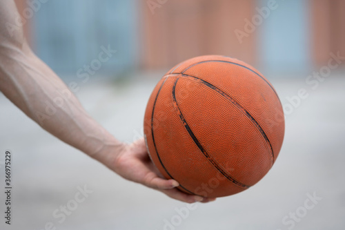 Basketball in the hands on the street © Vladimir