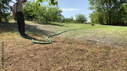 Hydroseeding of lawn grass on the lawn of a country house. Video 4k. photo