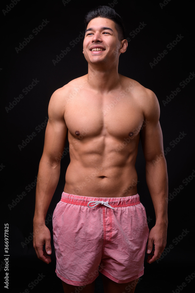 Fototapeta premium Young handsome muscular man shirtless against black background