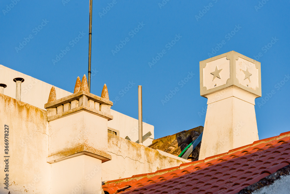 chimney and tiled roof of a traditional house, in Tavira, Algarve, Portugal
