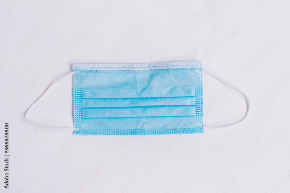 Blue medical mask on a white background. Personal protective equipment. Blue medical mask on a white background. Personal protective equipment.