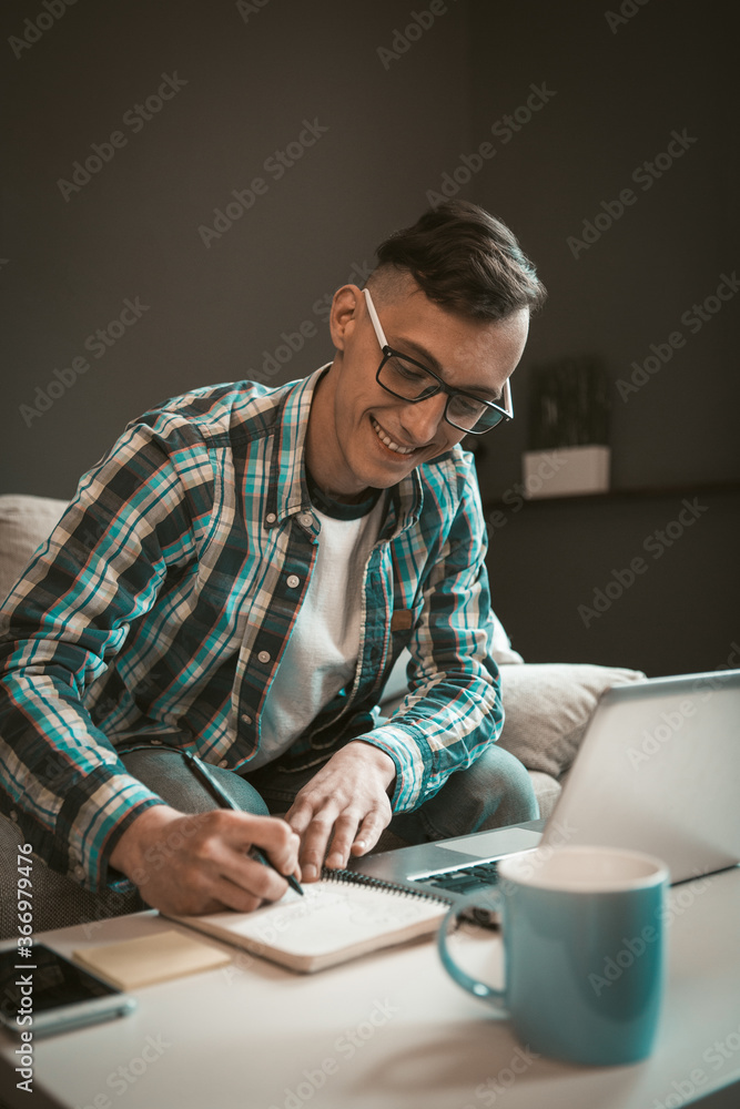 Portrait of happy freelance man working on project at home office. Modern concept of remote work on freelance. Portrait of happy freelance man working on project at home office. Modern concept of remote work on freelance.