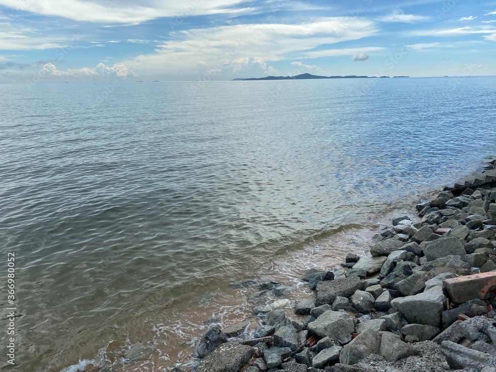 blue sky with clouds and water of the sea , stone on the beach blue sky with clouds and water of the sea , stone on the beach