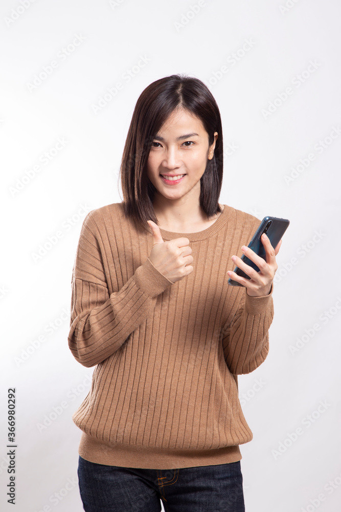The Asian woman standing on the white background. The Asian woman standing on the white background.