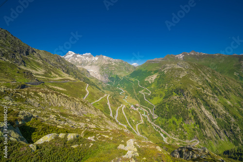 Swiss alps pass in summer with lake and blue sky