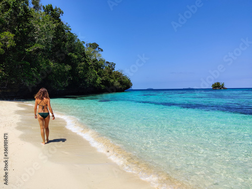 Young woman walking on paradise beach in Raja Ampat,  Papua, Indonesia © Patricia