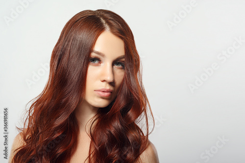 beauty portrait of a red-haired woman on a white background.