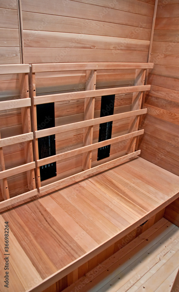 Inside a wooden dry heat sauna with no people.