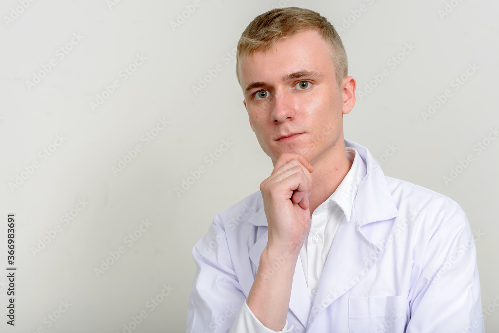 Portrait of young man doctor with blond hair