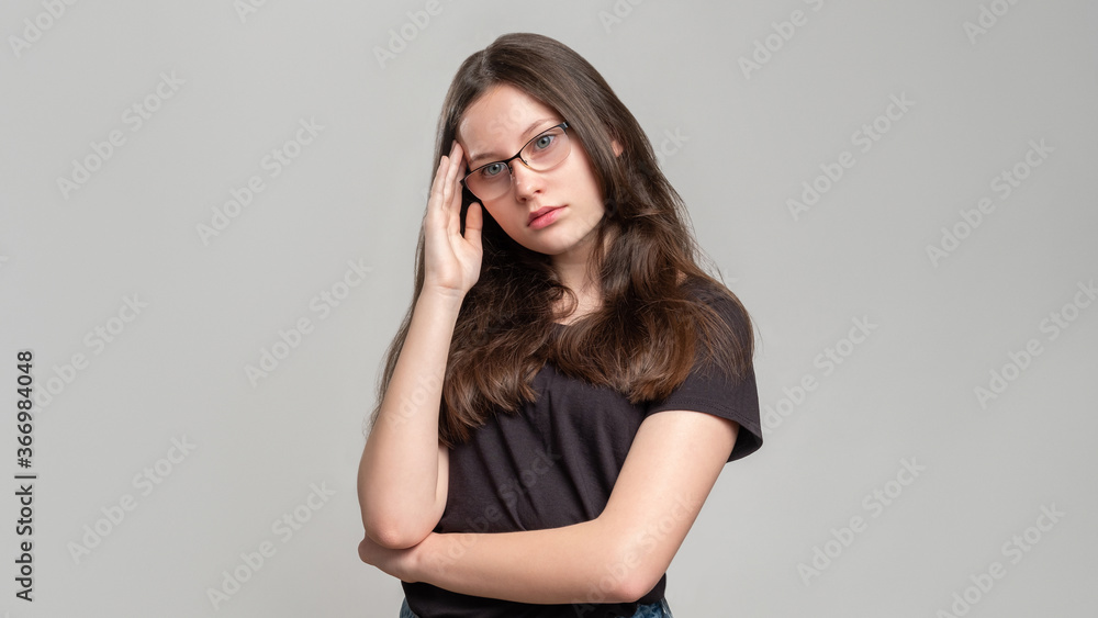 Concerned woman portrait. Trouble stress. Puzzled thoughtful lady with headache isolated on gray copy space. Anxiety crisis. Female insecurity. Concerned woman portrait. Trouble stress. Puzzled thoughtful lady with headache isolated on gray copy space. Anxiety crisis. Female insecurity.