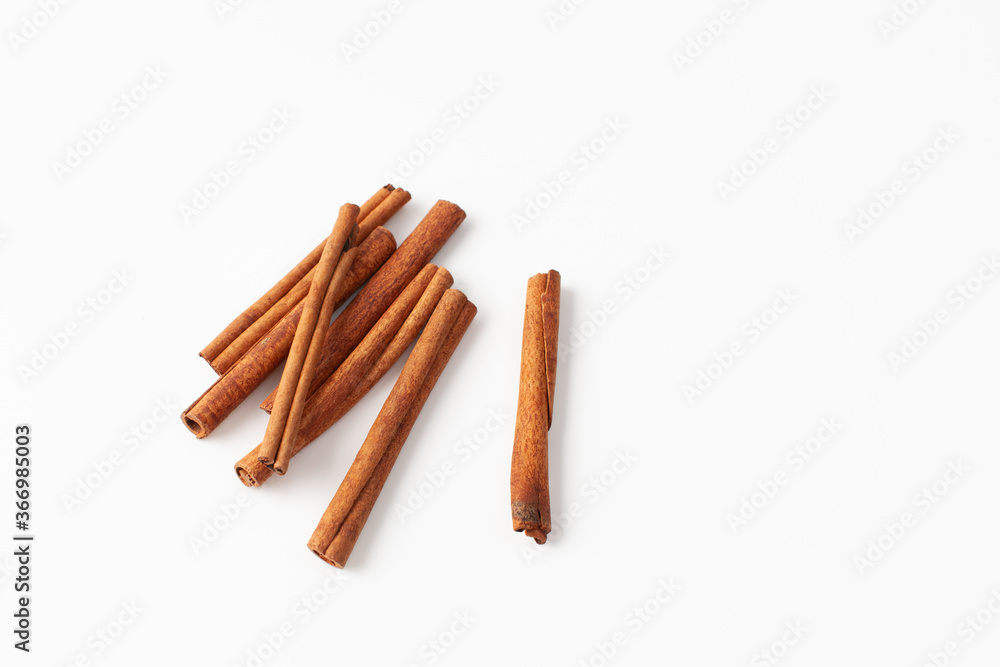 Cinnamon sticks on white background, place for text