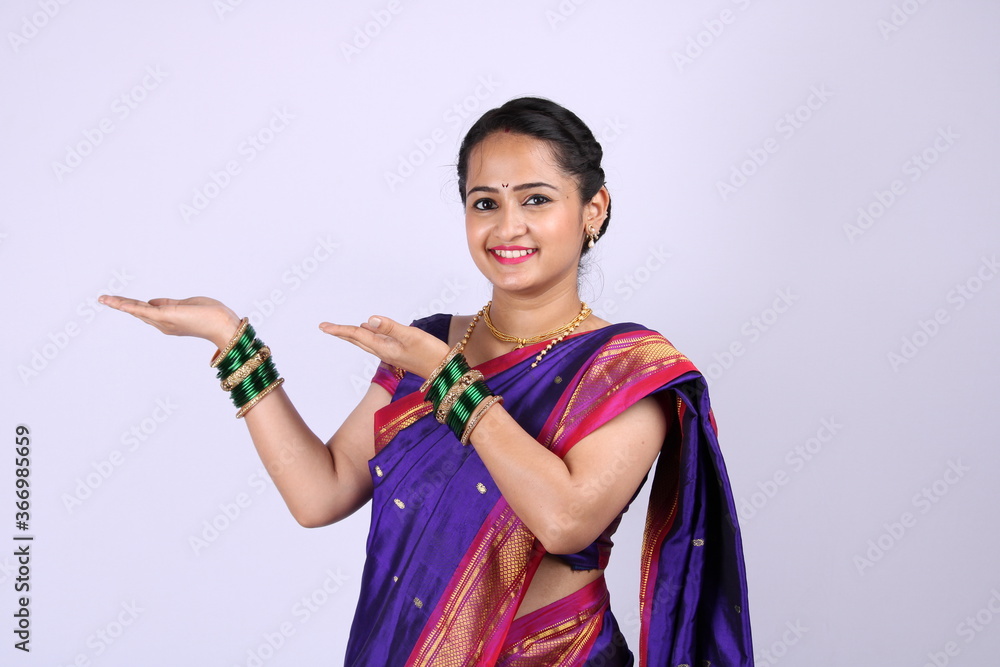 Beautiful Indian girl wearing sari showing hand gestures.