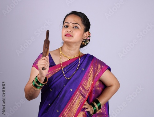 Canvas Print Beautiful Indian woman or girl holding rolling pin in hand