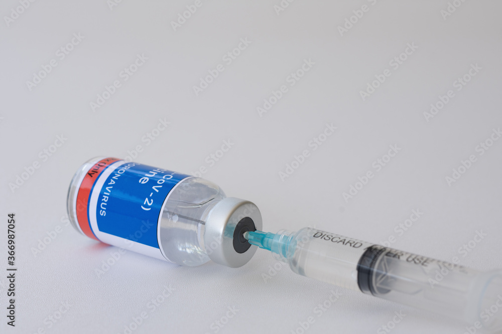 Close-up vaccine vials and syringe for prevention, immunization, and treatment from Coronavirus (COVID-19) or SARS-CoV-2. Pandemic COVID-19 virus and protection against the Coronavirus concept. Close-up vaccine vials and syringe for prevention, immunization, and treatment from Coronavirus (COVID-19) or SARS-CoV-2. Pandemic COVID-19 virus and protection against the Coronavirus concept.