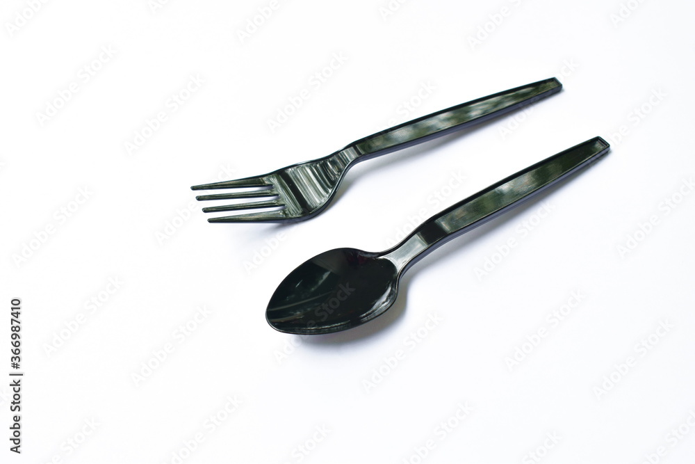 black plastic spoon and fork for single used on white background black plastic spoon and fork for single used on white background