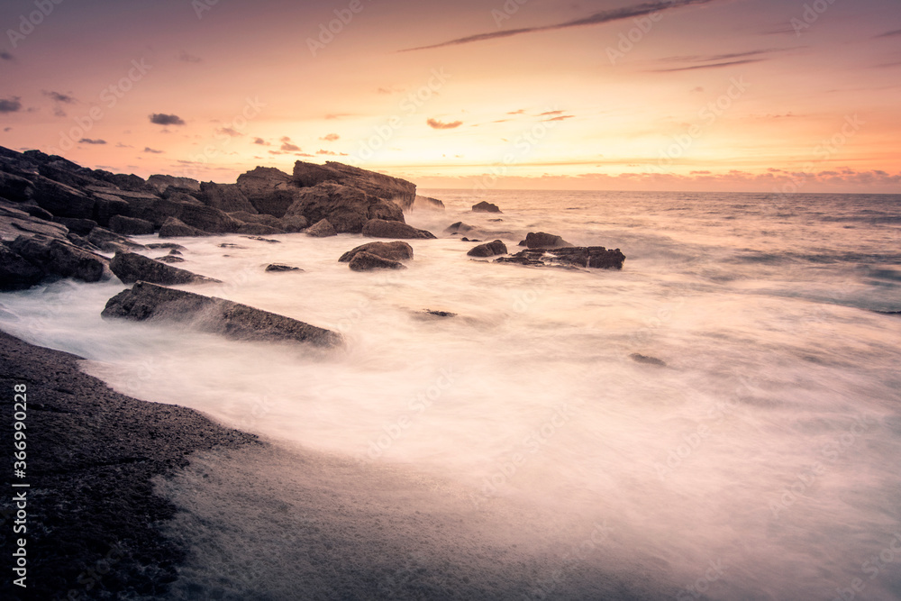 Obraz premium ATARDECER EN LA UNA COSTA CON ROCAS