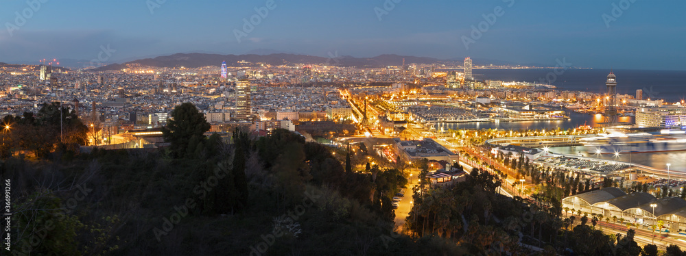 Barcelona - The panorama of the city with the harbor at the dusk.